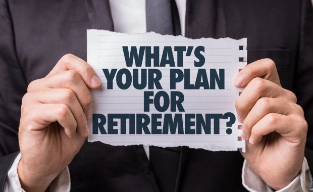 A man wearing black suit holding a paper that read Whats Your Plan for Retirement.Consider Retirement Plan Consulting