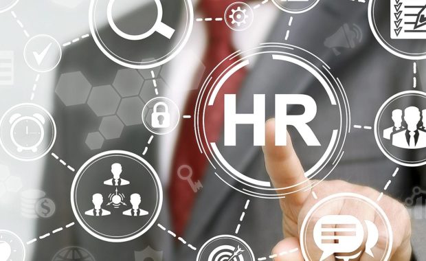 HR professional presses HR icon on a virtual screen, a concept of what HR solutions are